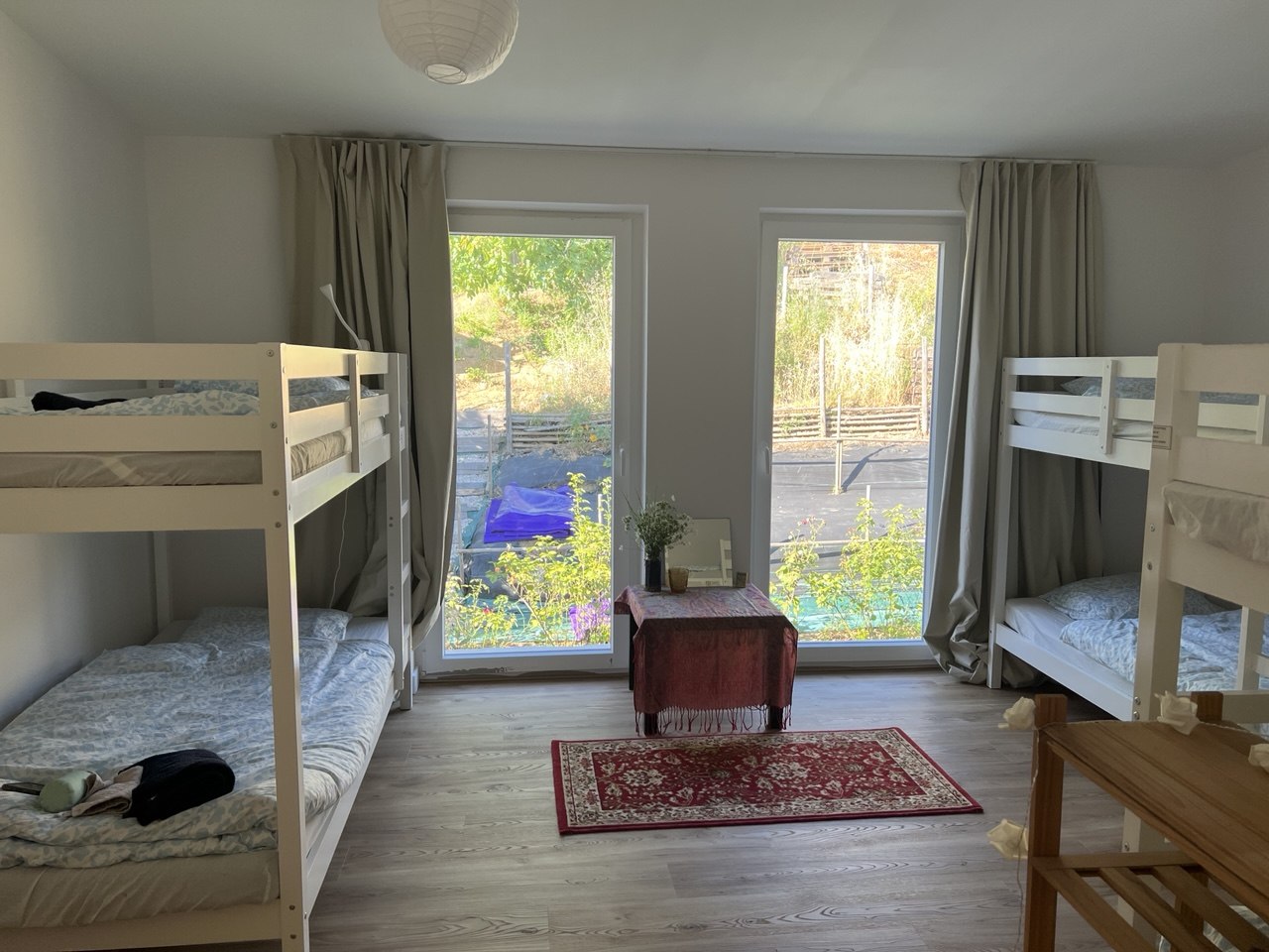 Shared bedroom with bunk beds and garden doors